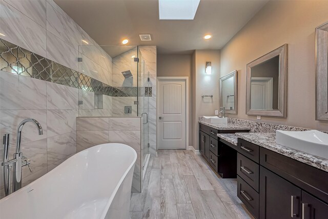 4307 Hershe St, Houston, TX 77020 - bathroom with a stall shower, a soaking tub, vanity, a skylight, and recessed lighting