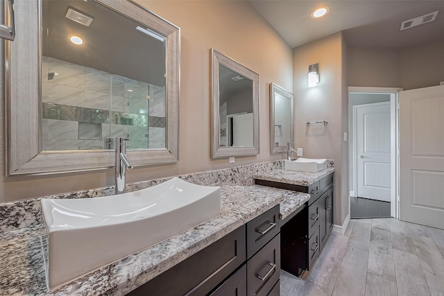 4307 Hershe St, Houston, TX 77020 - full bath featuring a stall shower, two vanities, recessed lighting, and baseboards