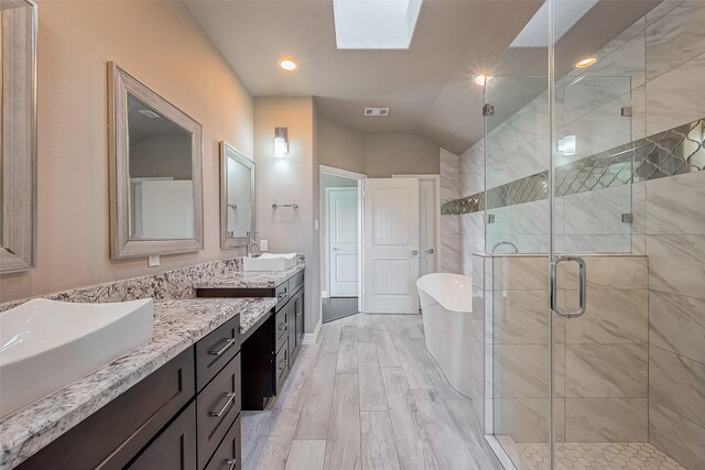 4307 Hershe St, Houston, TX 77020 - full bath featuring double vanity, a stall shower, a freestanding tub, a skylight, and lofted ceiling