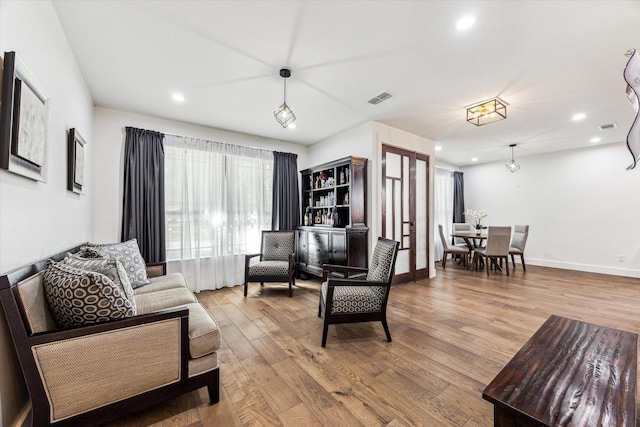 1702 De Milo Dr, Houston, TX 77018 - living room featuring wood finished floors, recessed lighting, and baseboards