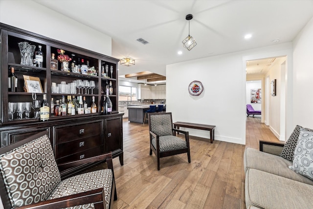 1702 De Milo Dr, Houston, TX 77018 - bar with light wood-type flooring, pendant lighting, baseboards, recessed lighting, and a sink