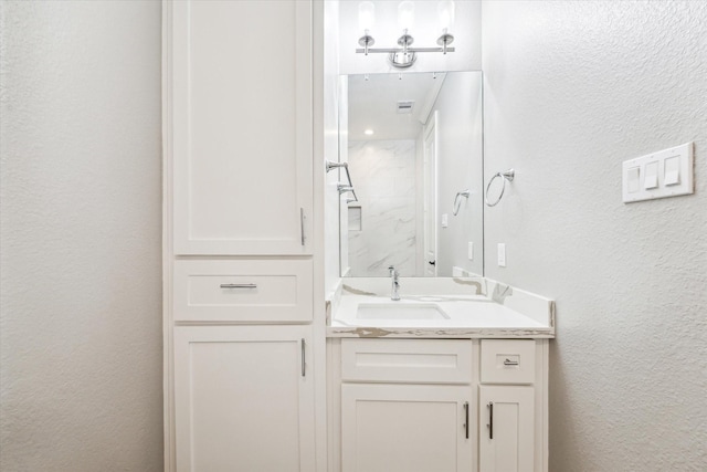 1702 De Milo Dr, Houston, TX 77018 - bathroom featuring a textured wall, vanity, and a shower