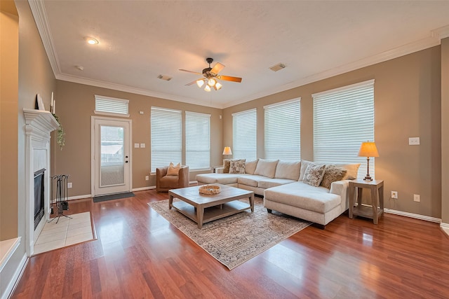 2500 Amy Lee Dr, Conroe, TX 77304 - living room with ceiling fan, wood finished floors, ornamental molding, and a fireplace with flush hearth