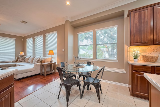 2500 Amy Lee Dr, Conroe, TX 77304 - dining area featuring crown molding and light tile patterned floors