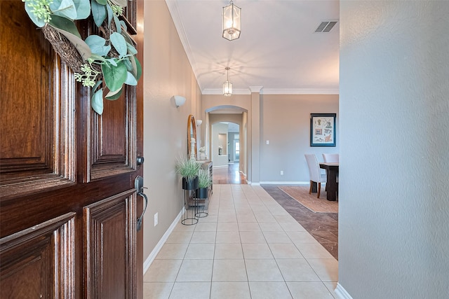 2500 Amy Lee Dr, Conroe, TX 77304 - foyer with arched walkways, light tile patterned floors, and ornamental molding