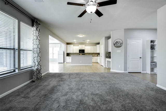 16438 Sheffield Run Dr, Houston, TX 77084 - unfurnished living room with light carpet, ceiling fan, and baseboards