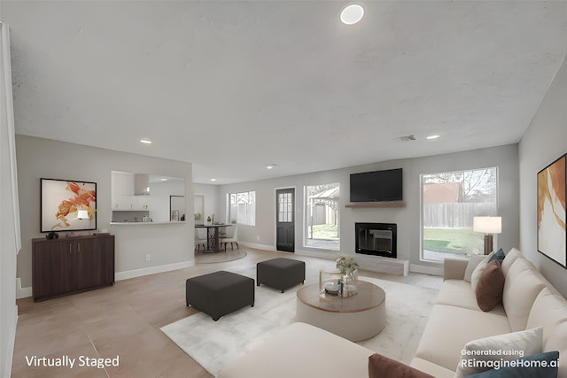 9602 John Bank Dr, Spring, TX 77379 - living area with baseboards, recessed lighting, and a glass covered fireplace