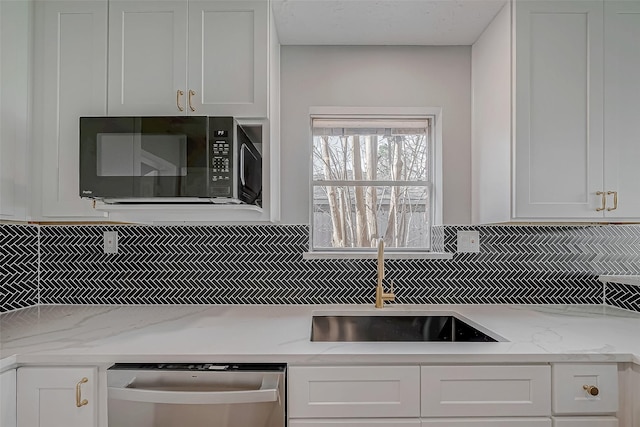 9602 John Bank Dr, Spring, TX 77379 - kitchen featuring black microwave, decorative backsplash, stainless steel dishwasher, and white cabinets