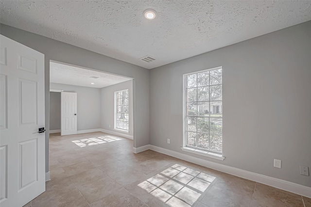 9602 John Bank Dr, Spring, TX 77379 - unfurnished room with baseboards, a textured ceiling, and light tile patterned flooring