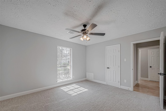 9602 John Bank Dr, Spring, TX 77379 - unfurnished bedroom featuring carpet floors, a textured ceiling, baseboards, and ceiling fan