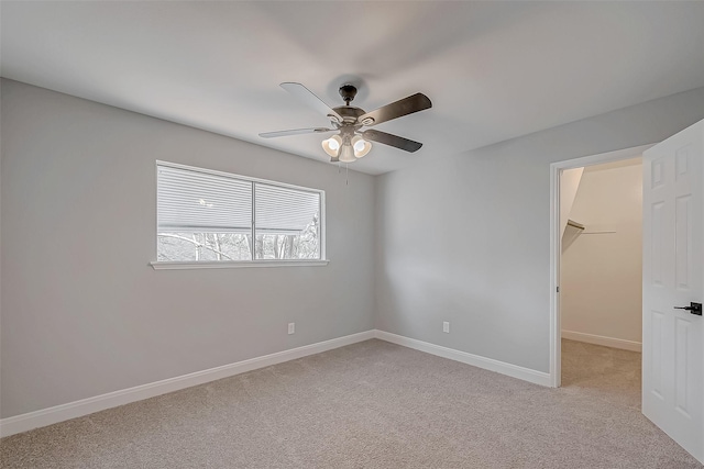 9602 John Bank Dr, Spring, TX 77379 - unfurnished bedroom featuring light colored carpet, a walk in closet, baseboards, and ceiling fan