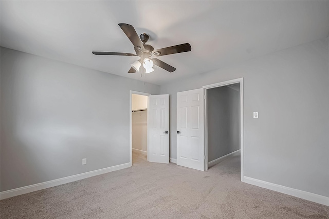 9602 John Bank Dr, Spring, TX 77379 - unfurnished bedroom with baseboards, a walk in closet, carpet, ceiling fan, and a closet