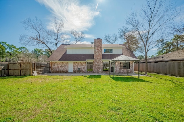 9602 John Bank Dr, Spring, TX 77379 - rear view of house with a patio, a gazebo, brick siding, and a chimney