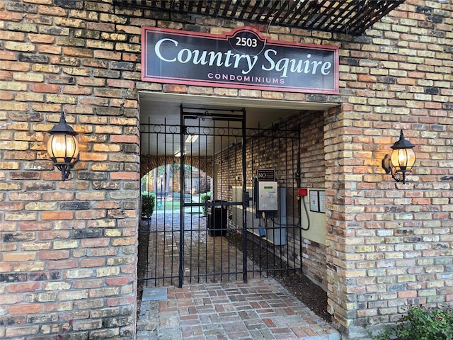 2503 Mccue Rd Unit 13, Houston, TX 77056 - property entrance with brick siding and a gate