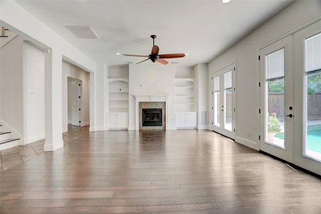 2209 Macarthur St, Houston, TX 77030 - unfurnished living room featuring built in features, hardwood / wood-style floors, healthy amount of natural light, and recessed lighting