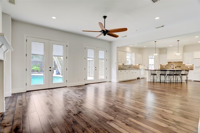 2209 Macarthur St, Houston, TX 77030 - living room with french doors, ceiling fan, recessed lighting, dark wood-style floors, and baseboards
