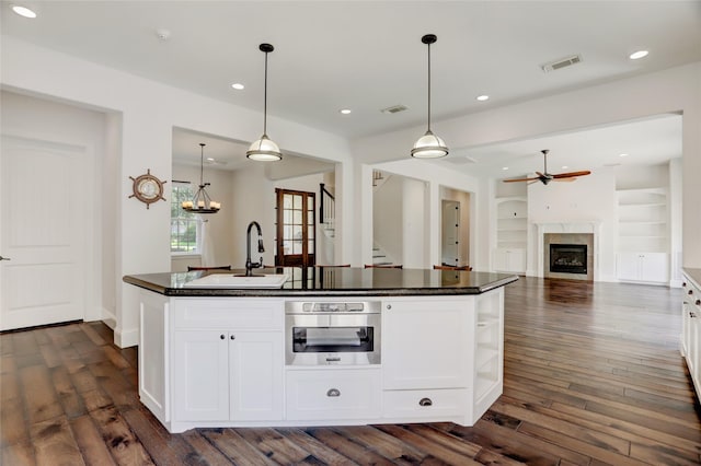 2209 Macarthur St, Houston, TX 77030 - kitchen featuring a sink, ceiling fan, dark countertops, white cabinetry, and recessed lighting