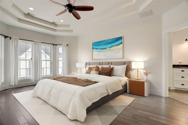 2209 Macarthur St, Houston, TX 77030 - bedroom with a tray ceiling, light wood-type flooring, baseboards, ensuite bathroom, and recessed lighting