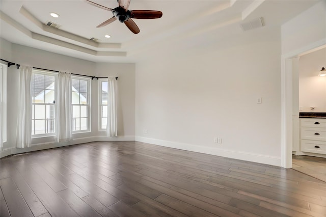 2209 Macarthur St, Houston, TX 77030 - spare room featuring a tray ceiling, a ceiling fan, dark wood-style flooring, baseboards, and recessed lighting