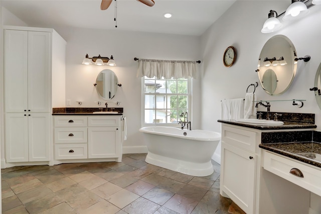 2209 Macarthur St, Houston, TX 77030 - full bath featuring two vanities, a soaking tub, baseboards, ceiling fan, and recessed lighting