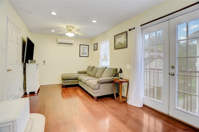 2209 Macarthur St, Houston, TX 77030 - living room with a wall mounted AC, wood finished floors, recessed lighting, a ceiling fan, and baseboards