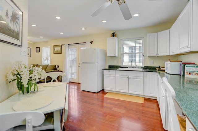 2209 Macarthur St, Houston, TX 77030 - kitchen with white appliances, a sink, ceiling fan, white cabinetry, and light wood finished floors