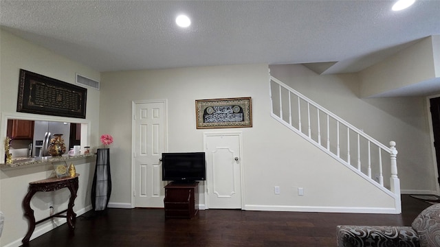 1805 Stoney Brook Dr Unit 103, Houston, TX 77063 - living area with wood finished floors, stairs, baseboards, a textured ceiling, and recessed lighting