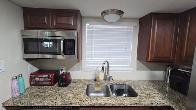 1805 Stoney Brook Dr Unit 103, Houston, TX 77063 - kitchen with stainless steel microwave, a sink, and light stone countertops