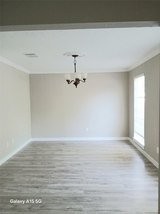 17931 Elk River Cir, Houston, TX 77090 - empty room with crown molding, light wood finished floors, a chandelier, and baseboards