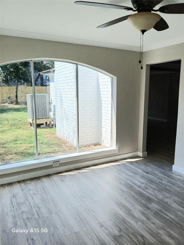 17931 Elk River Cir, Houston, TX 77090 - unfurnished room featuring healthy amount of natural light, a ceiling fan, wood finished floors, and baseboards