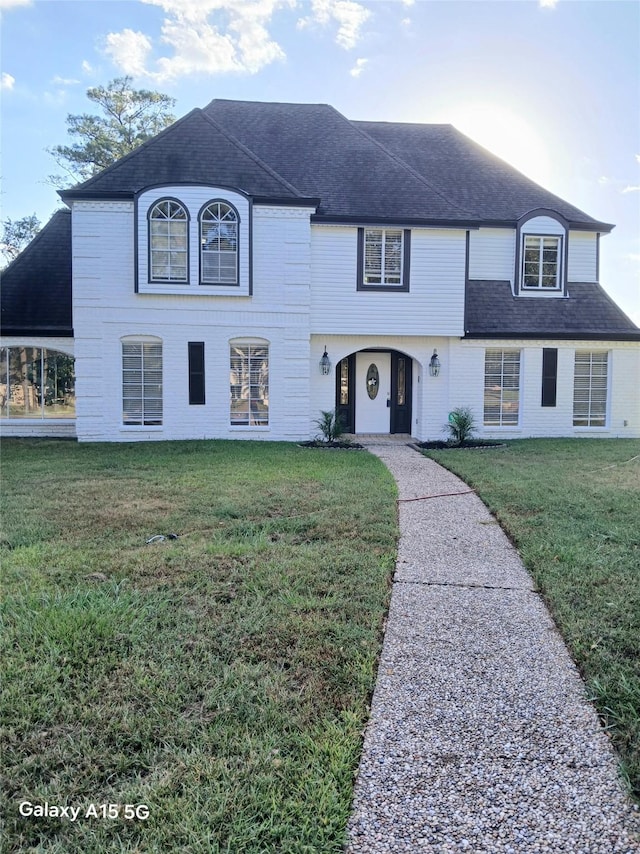 17931 Elk River Cir, Houston, TX 77090 - french country style house with a front yard and a shingled roof