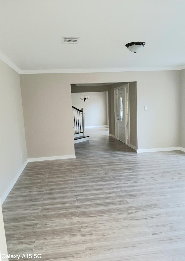 17931 Elk River Cir, Houston, TX 77090 - empty room featuring a chandelier, ornamental molding, wood finished floors, and baseboards