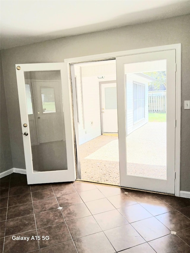 17931 Elk River Cir, Houston, TX 77090 - doorway with tile patterned flooring and baseboards