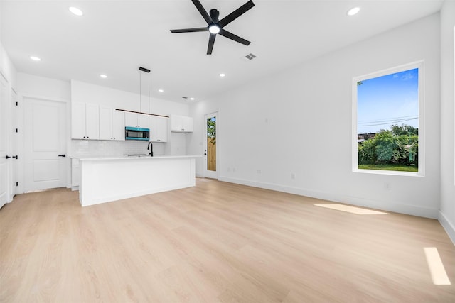 4337 Clover St A-B, Unit A-B Houston, TX 77051 - unfurnished living room with healthy amount of natural light, recessed lighting, a ceiling fan, and light wood-type flooring