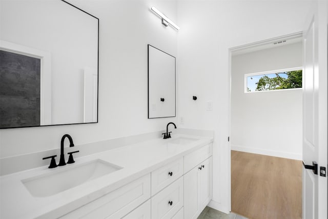 4337 Clover St A-B, Unit A-B Houston, TX 77051 - bathroom featuring double vanity, baseboards, and wood finished floors