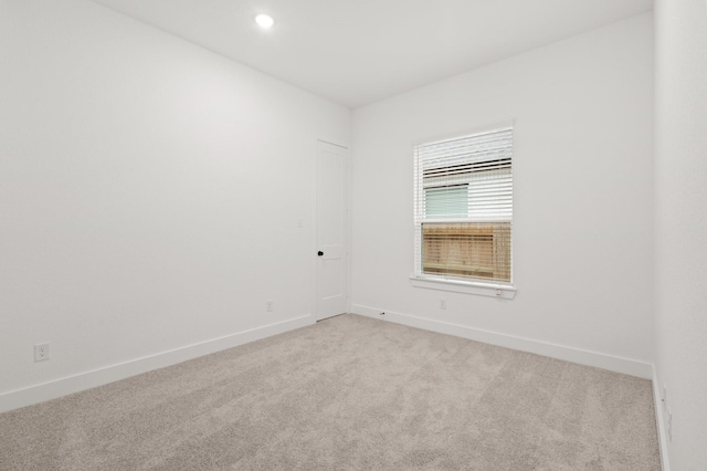 16154 Rustling Woods Rd, Conroe, TX 77302 - empty room featuring light carpet, baseboards, and recessed lighting