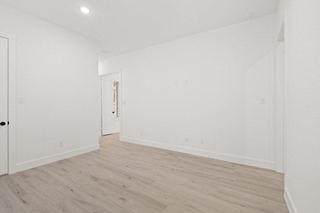 16154 Rustling Woods Rd, Conroe, TX 77302 - empty room with light wood-type flooring, baseboards, and recessed lighting
