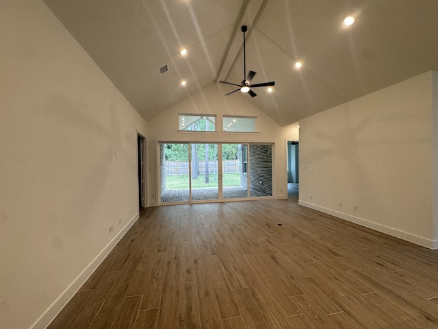 16154 Rustling Woods Rd, Conroe, TX 77302 - empty room featuring high vaulted ceiling, wood finished floors, a ceiling fan, and beam ceiling