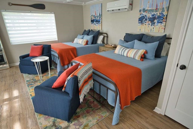 450 County Road 206, Sargent, TX 77414 - bedroom featuring wood finished floors, a wall mounted air conditioner, and ornamental molding