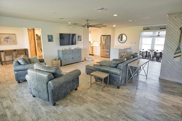 450 County Road 206, Sargent, TX 77414 - living room with ceiling fan, light wood-style flooring, recessed lighting, and a textured ceiling