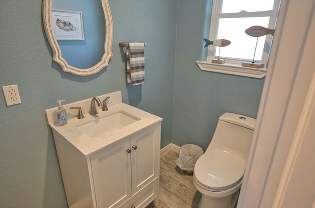 450 County Road 206, Sargent, TX 77414 - bathroom with toilet, vanity, wood finished floors, and baseboards