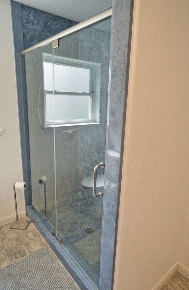 450 County Road 206, Sargent, TX 77414 - bathroom featuring wood finished floors, a stall shower, and baseboards