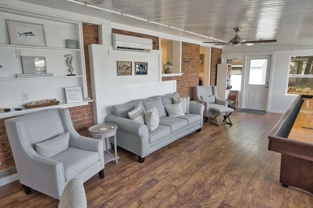 450 County Road 206, Sargent, TX 77414 - living area featuring a wall mounted AC, wood finished floors, ceiling fan, brick wall, and built in features