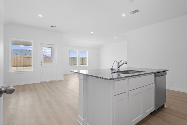 305 Robin St, Angleton, TX 77515 - kitchen featuring dishwasher, stone countertops, a sink, light wood finished floors, and open floor plan