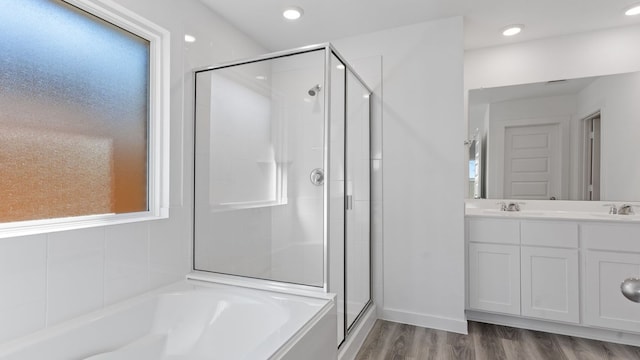 305 Robin St, Angleton, TX 77515 - bathroom with a shower stall, a garden tub, wood finished floors, double vanity, and recessed lighting