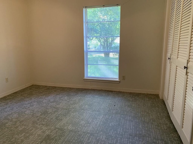 26405 Easy St, Magnolia, TX 77355 - unfurnished bedroom with carpet floors, multiple windows, a closet, and baseboards
