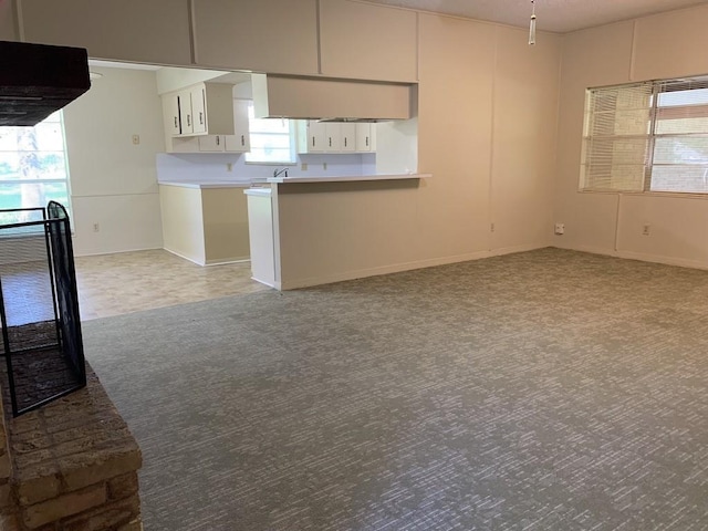 26405 Easy St, Magnolia, TX 77355 - kitchen with light carpet, light countertops, white cabinets, and baseboards