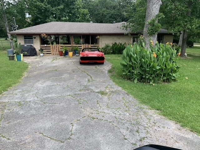 26405 Easy St, Magnolia, TX 77355 - ranch-style home with asphalt driveway, a front lawn, and brick siding