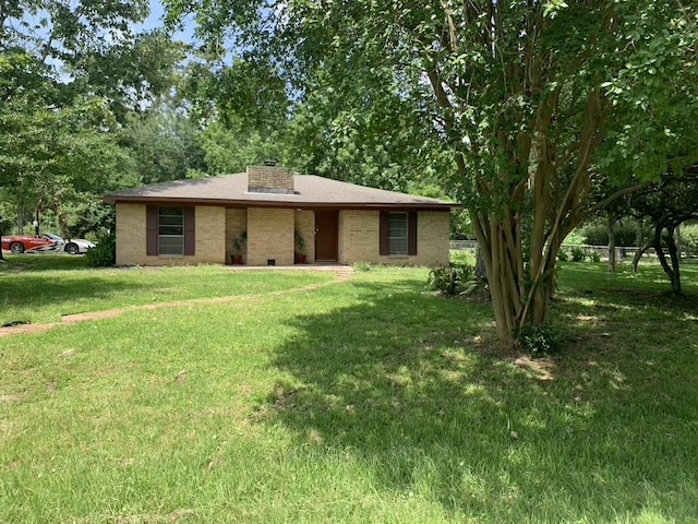 26405 Easy St, Magnolia, TX 77355 - view of front facade featuring a front lawn, brick siding, and a chimney