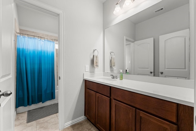 819 Spruce Pine Dr, Conroe, TX 77318 - full bathroom with vanity, tile patterned floors, shower / bath combo with shower curtain, and baseboards